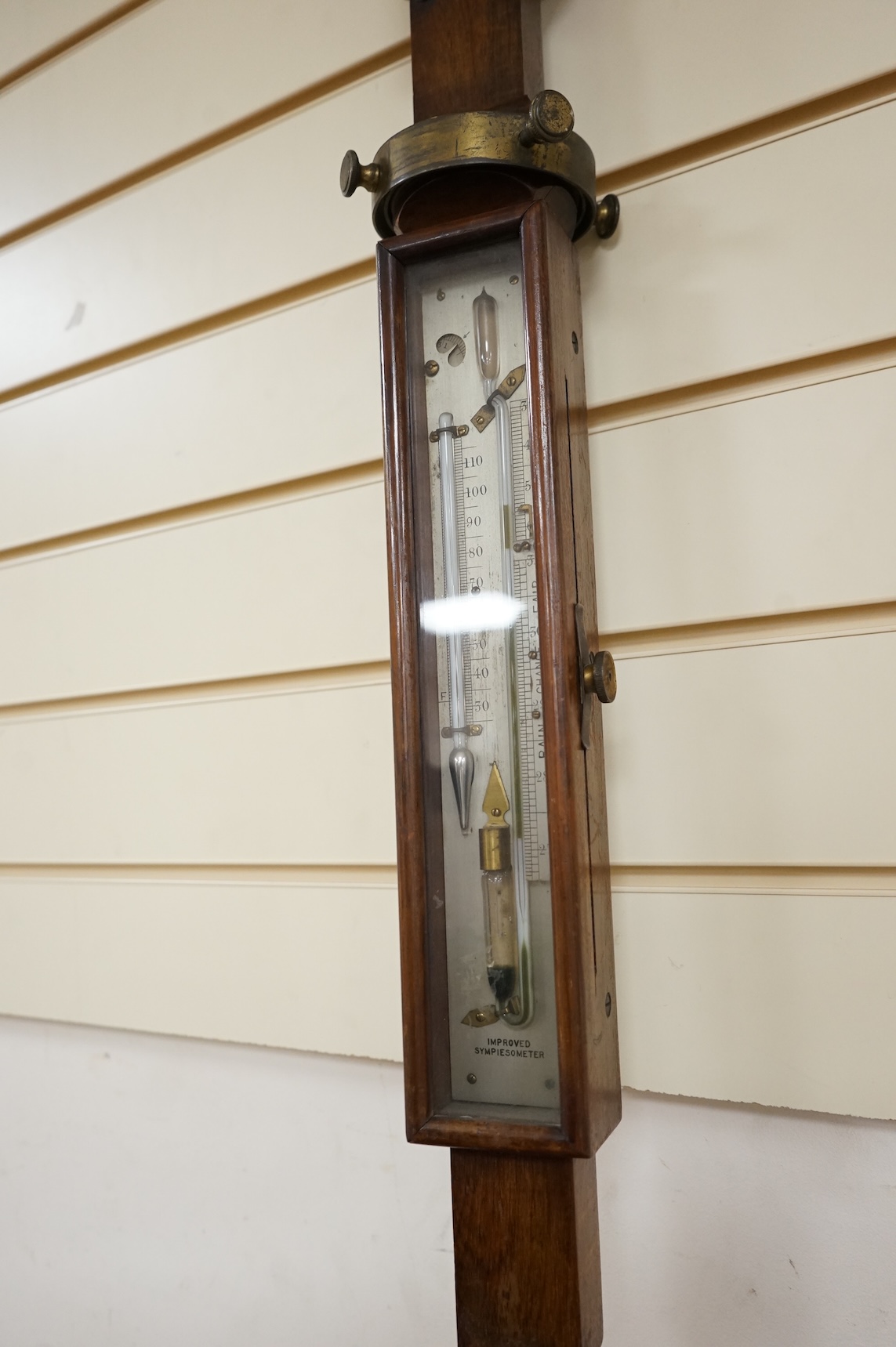 A 19th century oak marine stick barometer by Whyte Thomson, Glasgow, with ‘improved sympiesometer’ and thermometer to the front, with part of the brass gimbal holder still present, 96cm high, CITES Submission reference Y
